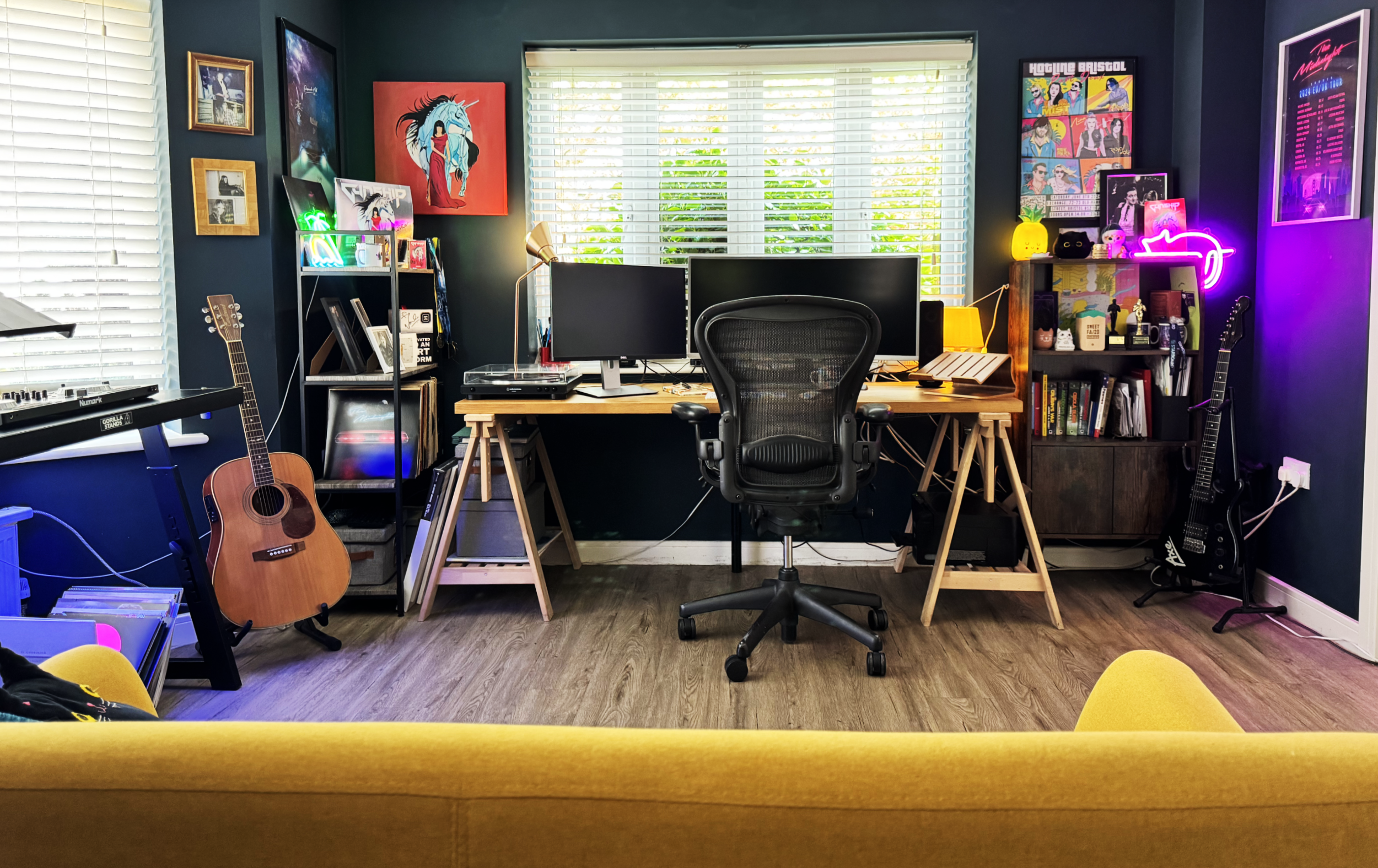 A wide shot of my office, showing neon lights, posters of bands on the wall, guitars, DJ deck and lots of music memorabilia